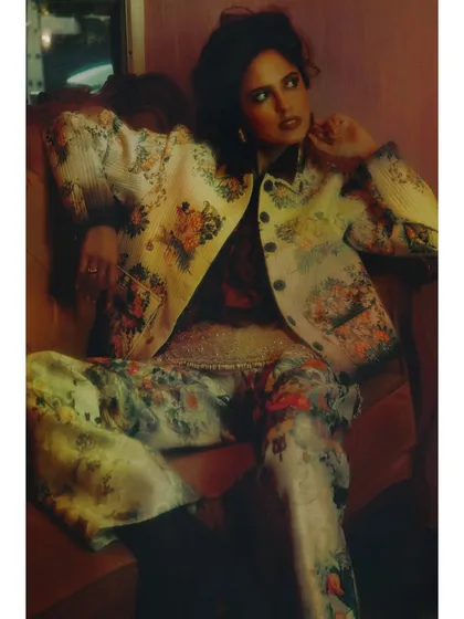 A closer look at the patterned suit from Chapter 6. The lighting is warm and hazy, suggesting that while the character is moving forward, the past still colors her perception.