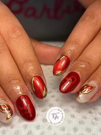 A bold and fiery red cat-eye manicure. This set is accented with hand-painted gold leaf designs, making it perfect for the festive season.