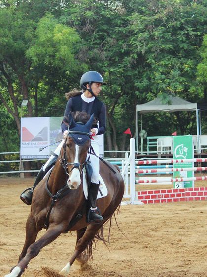 A rider and horse in action during the Auroville Horse Show. My competition team travels to various events to gain experience and bring home medals.