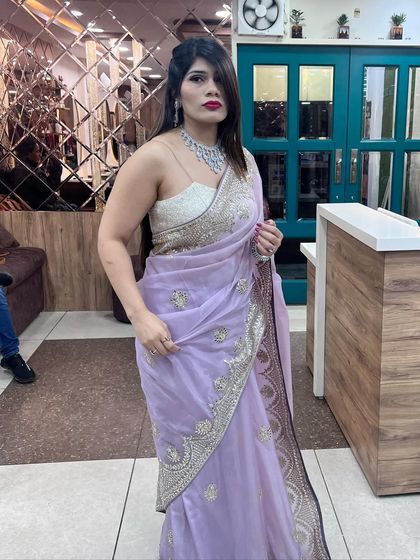 A classy and glamorous party look. This client looks stunning in a lavender saree, which we paired with a bold red lip, soft waves, and a sparkling diamond necklace.
