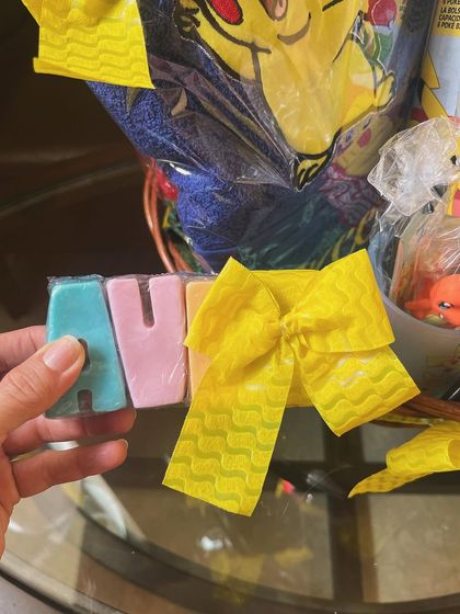 A personalized touch with custom-made soaps spelling out the child's name, 'Aveer'.