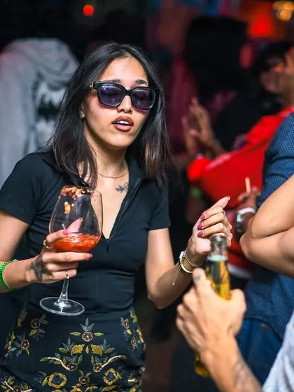 A stylish guest enjoying a drink and the music.