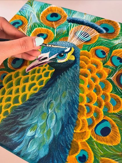 A macro shot of me adding fine white details to the peacock's head. It's these tiny, precise strokes that bring the entire painting together and give it a professional, finished look.