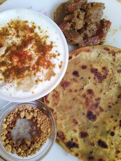 My Mix Veg Achaar is a crowd-pleaser, full of cauliflower, carrots, and turnips in a sweet and savoury masala. It’s a hearty pickle that can almost be a dish on its own, seen here with a sattu paratha and raita.