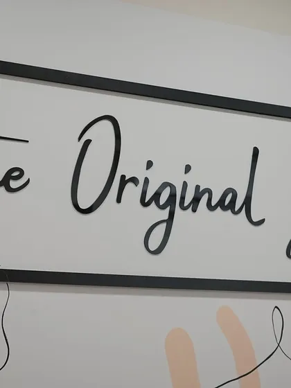 A close-up of our brand philosophy on the wall. We are here to help you uncover the best version of yourself.