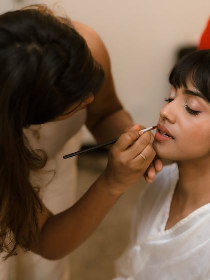 Another candid shot of the process. Perfecting the lip colour is one of the final, most important steps in creating a bridal look.
