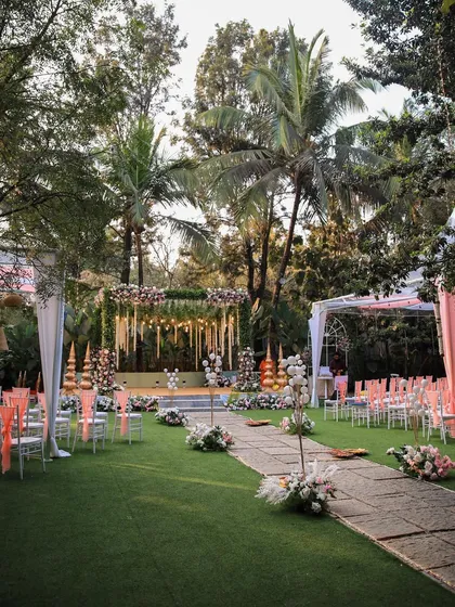 A collection of stunning wedding setups at The Farmhouse Collective. You can see the venue's versatility, from elegant morning ceremonies with floral mandaps to glamorous evening receptions with fairy lights and chic decor. This space is a blank canvas for your dream outdoor wedding in Bengaluru.