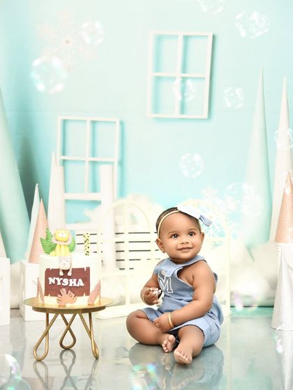 A moment of calm before the cake. This first birthday setup with a custom cake is ready for the celebration to begin.