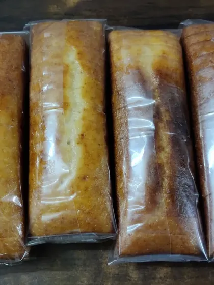 Four of my Mawa Rawa loaf cakes, individually wrapped to maintain freshness. This packaging makes them easy to store, transport, and give as gifts.