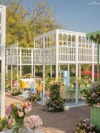 The multi-level trellis structures create a visually interesting and dynamic space for the brunch celebration.