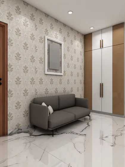 This image shows a simple yet elegant entryway or hallway with a comfortable sofa, patterned wallpaper, and a dual-toned wardrobe, demonstrating our solutions for transitional spaces.