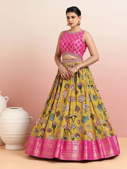 The full silhouette of the mustard and pink lehenga is both grand and graceful, perfect for festive twirls.