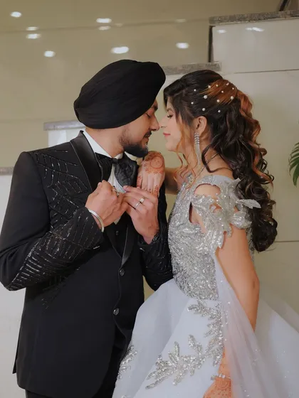 A romantic pose showing the couple's connection. The bride's pearl-studded hair and detailed gown are beautifully highlighted in this engagement portrait.