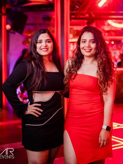 A stylish pair in black and red, matching the club's vibrant energy.