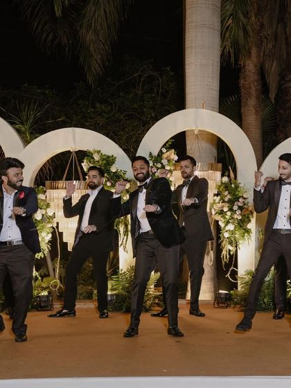 The groom and his groomsmen in a synchronized dance. We make sure the whole crew looks sharp and coordinated.