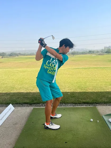 A player mid-swing, demonstrating the great form that comes from consistent practice at a quality facility like ours.