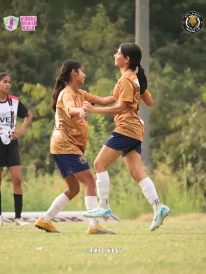A moment of celebration and teamwork on the pitch as two of our players celebrate a goal during a Women's Premier League match.