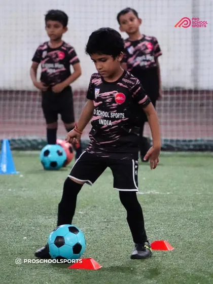 A young player navigates a cone drill, improving their dribbling and coordination.