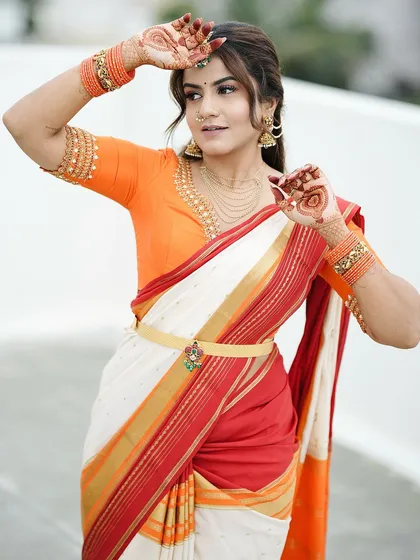 A playful pose showing off the simple mandala designs on both palms. It's a fun and chic way to wear mehendi.