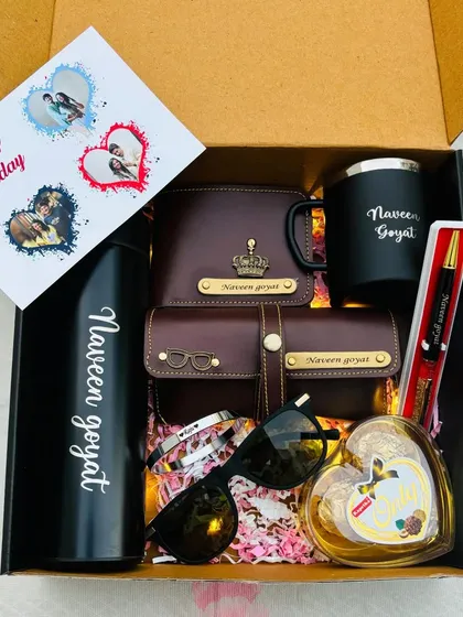 This birthday hamper is packed with style. It includes a personalized temperature bottle, mug, wallet, and sunglass holder, along with sunglasses, a heart-shaped chocolate box, and a custom birthday card.