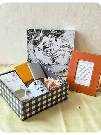 A thoughtful Rakhi hamper for a brother, including a "Best Brother" mug, a photo frame, and a selection of our treats.