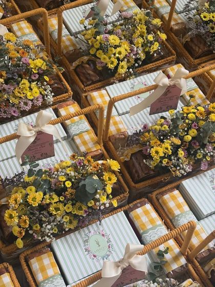 Another view of our beautiful summer-themed gift baskets, showcasing the fresh flowers and gingham-wrapped treats inside.