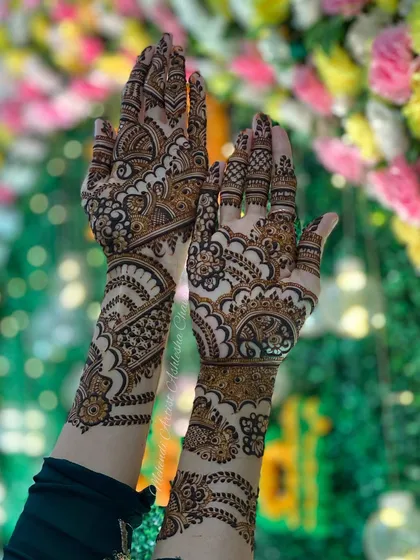 An Indo-Arabic design with a mix of bold and fine lines. The patterns are intricate and create a rich, textured look, set against a beautiful floral background.