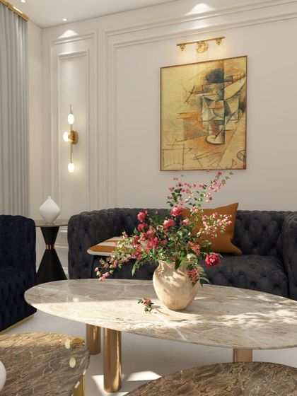 Another angle showing how flowers and a statement art piece can bring life and color to an elegant living room setup.