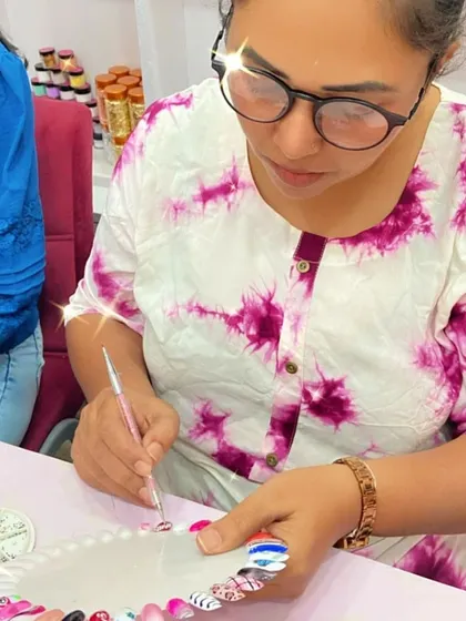 This student is practicing her nail art on a color wheel, experimenting with different designs and techniques.