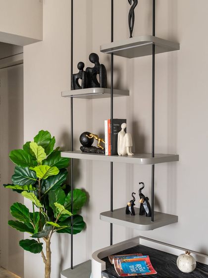 A corner that tells a story, stylishly. This beautifully detailed bookshelf, elevated with sleek SS rods, transforms the space into a true design statement. Minimal yet bold, functional yet artistic.