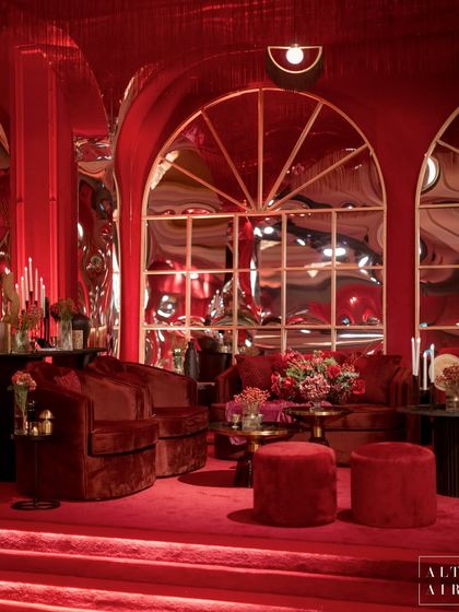 Distorted mirrors and arched windows were a key feature of the 'Le Rouge' sangeet, adding a surreal, artistic element to the opulent red decor. The design was all about creating a vibe that was sexy, dramatic, and unforgettable.