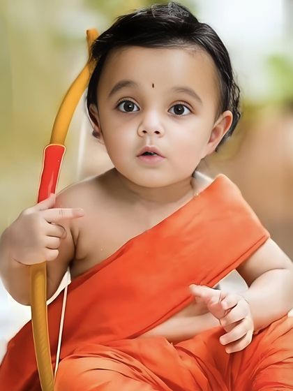 A close-up portrait of a baby boy dressed as Little Rama for Rama Navami. The focus is on his innocent expression and the simple, traditional attire.