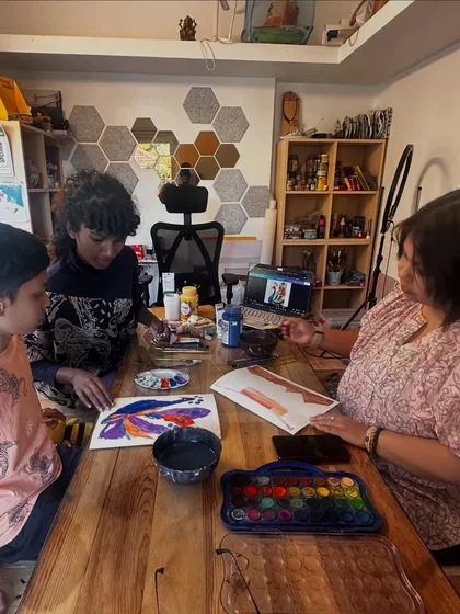 An instructor provides one-on-one guidance during a watercolor session. We ensure every child gets the personal attention they need to develop their technique and confidence.