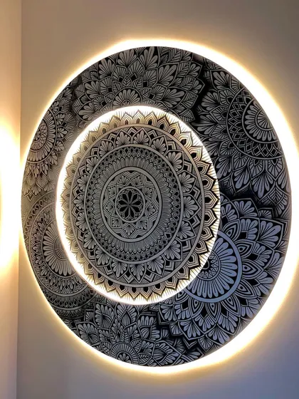 I love adding a touch of magic with backlighting. This custom layered mandala features a warm LED glow, turning the intricate artwork into a stunning light fixture that transforms the room's ambiance.