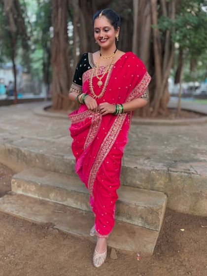 The full standing view of the pink velvet Nauvari saree against a natural backdrop. The drape is elegant, powerful, and deeply rooted in tradition.