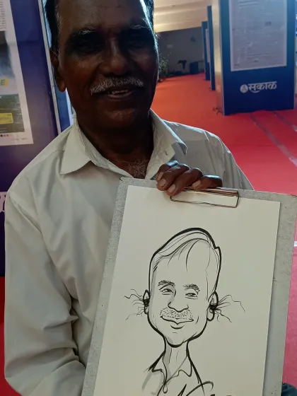 Another happy guest from the Sakal Media event in Kolhapur. The branded paper adds a professional touch, making the caricature a great piece of event memorabilia.
