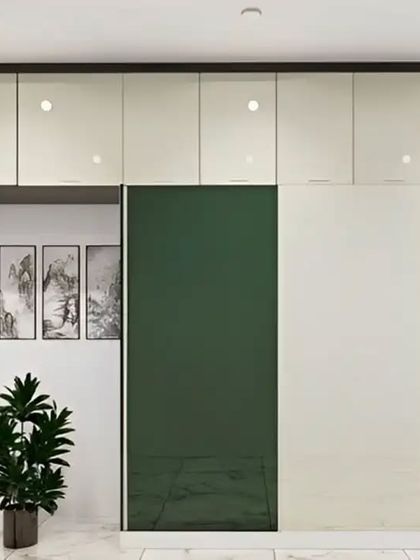 A modern wardrobe with a two-tone design, featuring glossy green and off-white sliding doors. This sleek and colorful storage solution adds a bold statement to any bedroom.