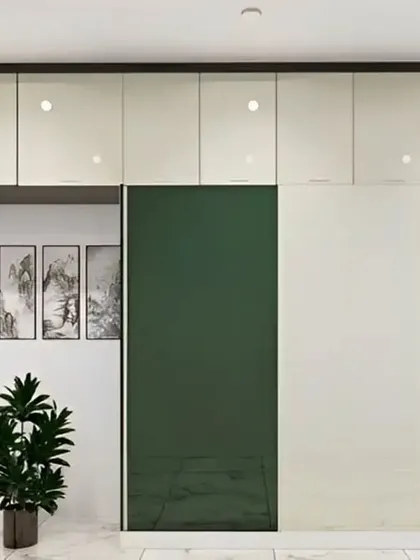 A modern wardrobe with a two-tone design, featuring glossy green and off-white sliding doors. This sleek and colorful storage solution adds a bold statement to any bedroom.