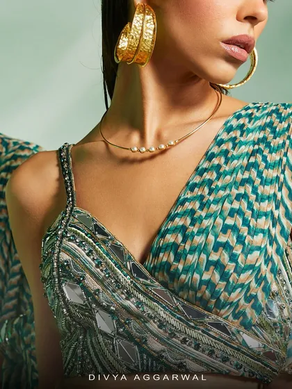 A detail of the Verity set, where a printed and hand-embroidered asymmetrical blouse is paired with a drape-style skirt for the modern woman.