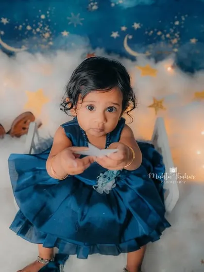 365 days of joy, giggles, and love. This one-year-old is celebrating her birthday among the clouds and stars.