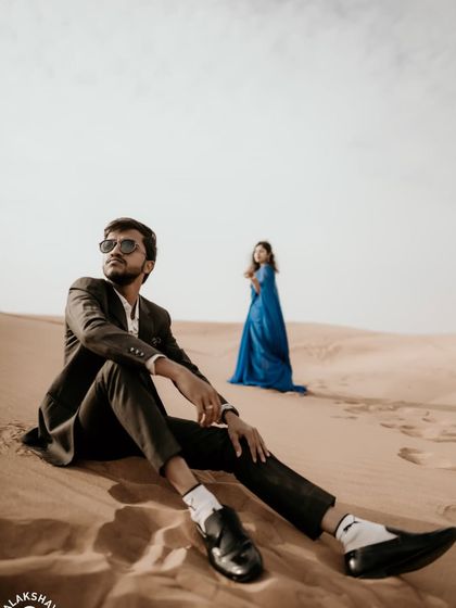 A creative shot with the groom in the foreground, creating depth and focusing on his perspective.