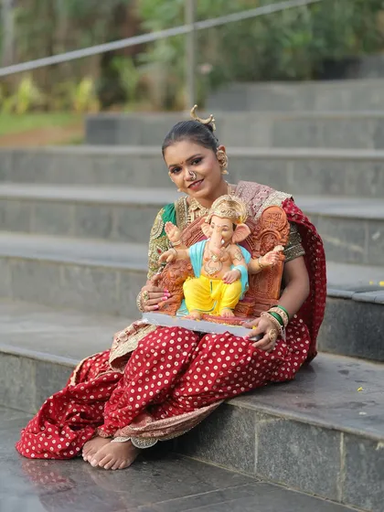 This red dotted Nauvari paired with a green embroidered blouse is another classic choice for the festival.