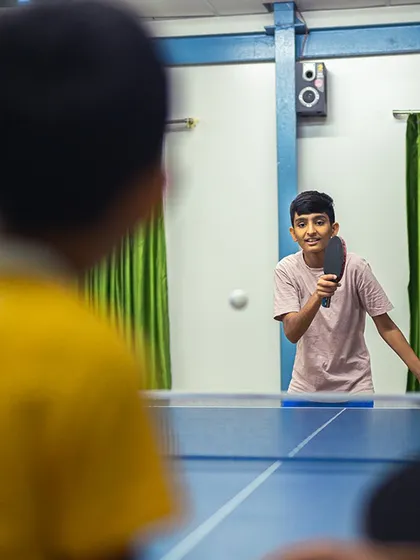 Two young players face off in a friendly but competitive match. Our facility is a great place for kids to learn sportsmanship and challenge their friends.