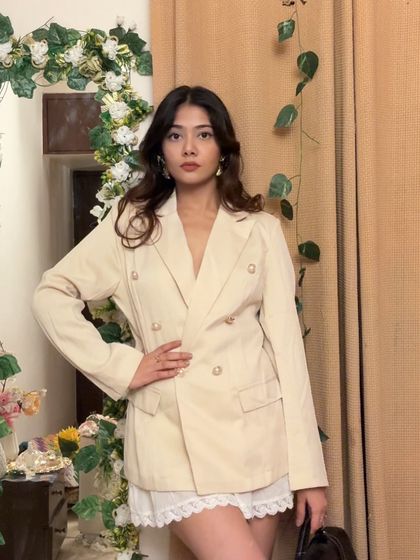 A closer look at this powerful blazer and skirt combination. Notice how the structured jacket is balanced by the softness of the skirt, creating a modern office outfit.