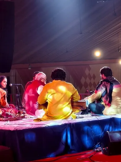 A candid moment on stage during the Mahakumbh festival. The connection between artists during a live performance is what creates musical magic.