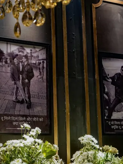 A close-up of the memory lane wall, where black-and-white photos of the couple were framed with heartfelt Hindi quotes, adding a deeply personal and poetic touch to the decor.