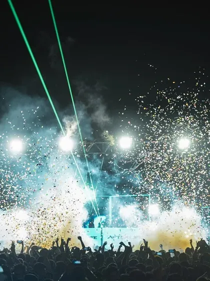 A view from the crowd during one of our explosive drops. We combine our high-energy EDM and trap music sets with a full visual production, including stage lights, lasers, and confetti blasts to make every moment epic.
