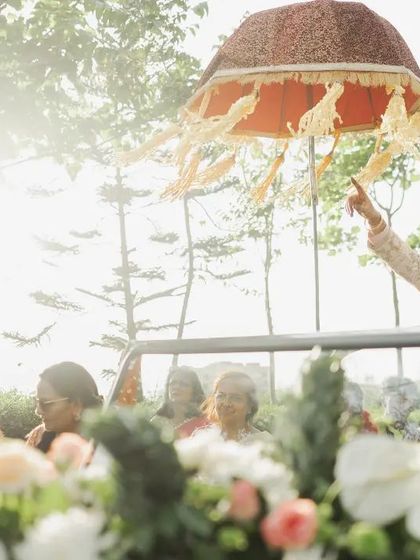 The groom's stylish arrival in a vintage car, bathed in the golden morning light.