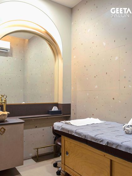 This is one of our serene and private treatment rooms at our Ahmedabad location. The minimalist design, soft lighting, and dedicated sink area create a perfect environment for you to switch off and enjoy your facial.