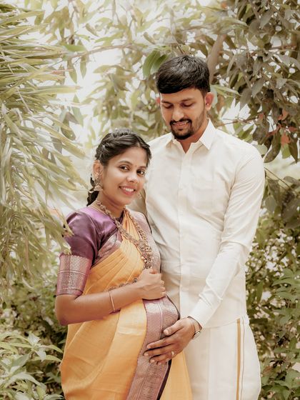 A simple and sweet portrait of the expecting couple in a garden setting. Their coordinated traditional outfits and the natural light create a soft and timeless feel.